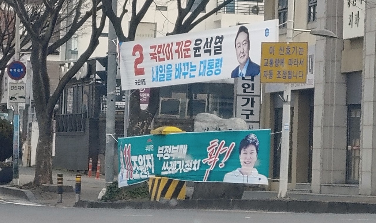 ▲선거 운동 첫 날 거리에 걸린 국민의당 윤석열 후보와 우리공화당 조원진 후보 현수막. 조 후보는 현수막에 박근혜씨의 사진을 넣었다. ⓒLicky Rooney